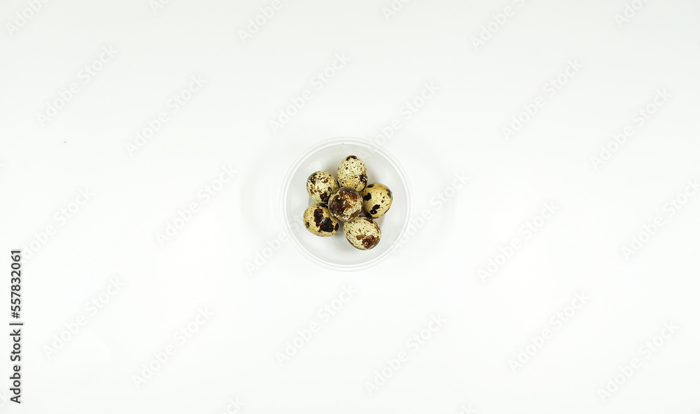 Top view of eggs quail in clear bowl on white background, isolated
Top view of eggs quail in clear bowl on white background, isolated