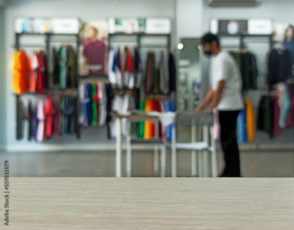 Empty brown wooden texture table and Defocused or Blurred background of clothing store with people activity bokeh image luxury and fashionable brand, can be used for montage or display your product Empty brown wooden texture table and Defocused or Blurred background of clothing store with people activity bokeh image luxury and fashionable brand, can be used for montage or display your product