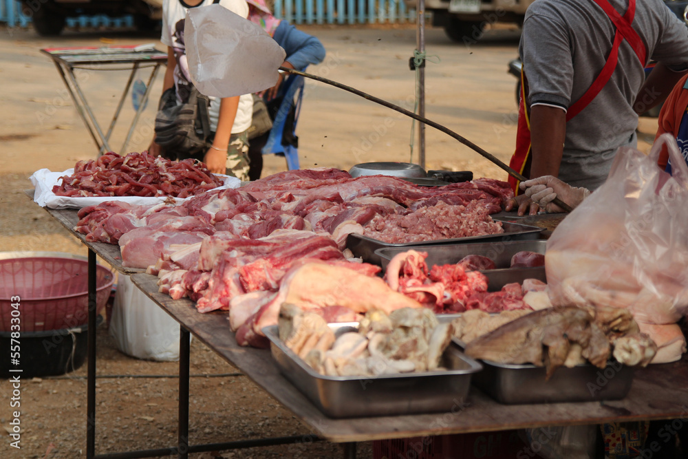 raw meat on a table for sale on a market at a warm sunny day