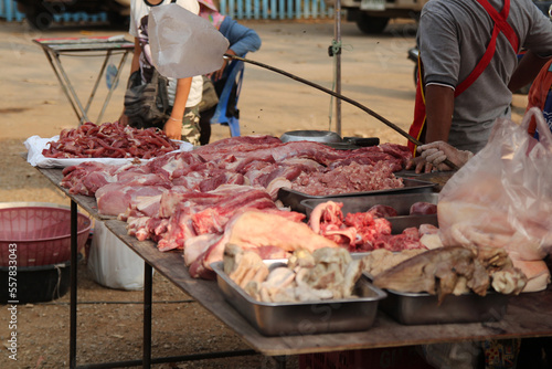 raw meat on a table for sale on a market at a warm sunny day