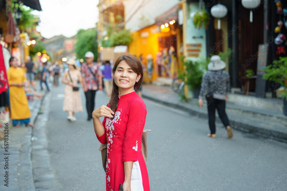 happy woman wearing Ao Dai Vietnamese dress, asian traveler sightseeing at Hoi An ancient town in central Vietnam. landmark and popular for tourist attractions. Vietnam and Southeast travel concept happy woman wearing Ao Dai Vietnamese dress, asian traveler sightseeing at Hoi An ancient town in central Vietnam. landmark and popular for tourist attractions. Vietnam and Southeast travel concept