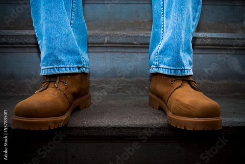 legs and boots of a man on stairs