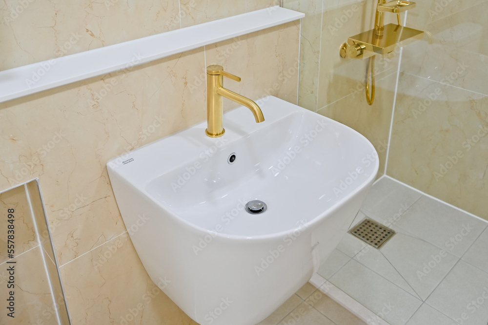 Fototapeta premium The faucet is in gold color, which gives it a very luxurious feel
