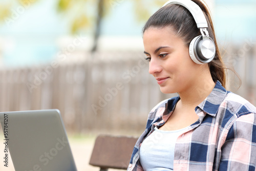Teen watching videos in a bench