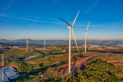 PANORAMIC VIEW OF WIND FARM OR WIND PARK, WITH HIGH WIND TURBINES FOR GENERATION ELECTRICITY WITH COPY SPACE. GREEN ENERGY CONCEPT, CAU DAT, DA LAT, VIETNAM