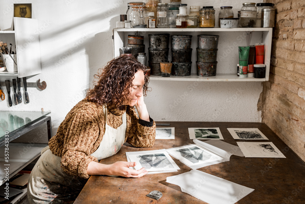 Female artisan inspecting engraved photos Female artisan inspecting engraved photos