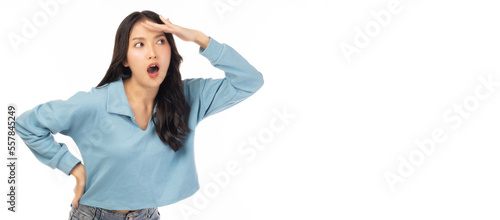 Excited happy young asian woman holding hand above her eyes and looking into copy space looking into distance expecting and searching for something with arm akimbo and smile face use for advertising