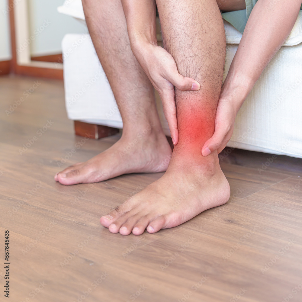 Man having leg pain due to Ankle Sprains or Achilles Tendonitis and Shin Splints ache. injuries, health and medical concept Man having leg pain due to Ankle Sprains or Achilles Tendonitis and Shin Splints ache. injuries, health and medical concept