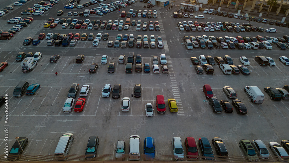 Fototapeta premium Parking. Aerial view of cars parked in line in a parking lot. Colored cars. drone view 