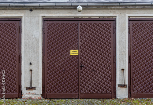 old garage door in a building with the sign "parken verboten" © tl6781