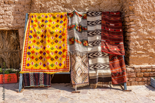 Saudi Arabia, Al-Ula, Arabic rugs hanging outdoors photo