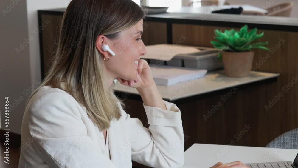 Smiling business woman working with laptop and typing keyboard while having breakfast at restaurant table Smiling business woman working with laptop and typing keyboard while having breakfast at restaurant table