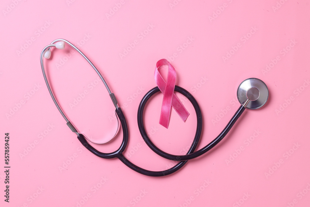 Pink ribbon breast cancer and stethoscope on pink background with copy space. Breast Cancer Awareness. Pink ribbon breast cancer and stethoscope on pink background with copy space. Breast Cancer Awareness.