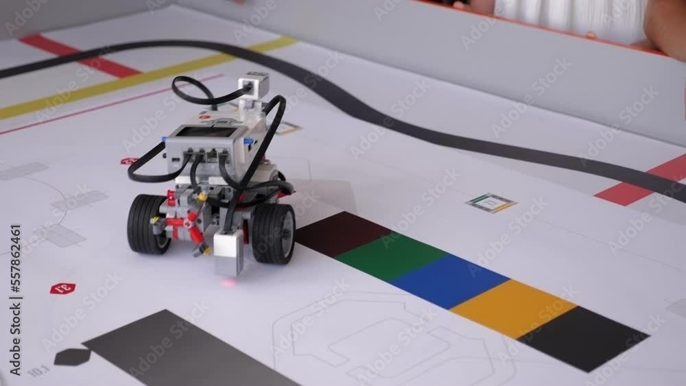 Robotics competitions. A group of children assembled robots from plastic parts in a robotics lesson and control them using the remote control. Robotics competitions. A group of children assembled robots from plastic parts in a robotics lesson and control them using the remote control.