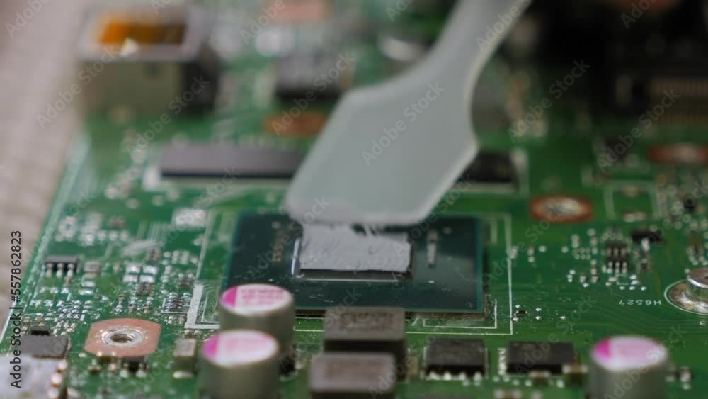 Applying thermal paste to the laptop processor. Thermal grease for computer. Service electronics and computers concept. Applying thermal paste to the laptop processor. Thermal grease for computer. Service electronics and computers concept.