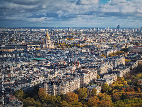 Sightseeing aerial view over the Paris city, France. Les Invalides building with golden dome seen on the horizon. Autumn parisian cityscape