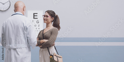 Young woman talking with her optometrist photo