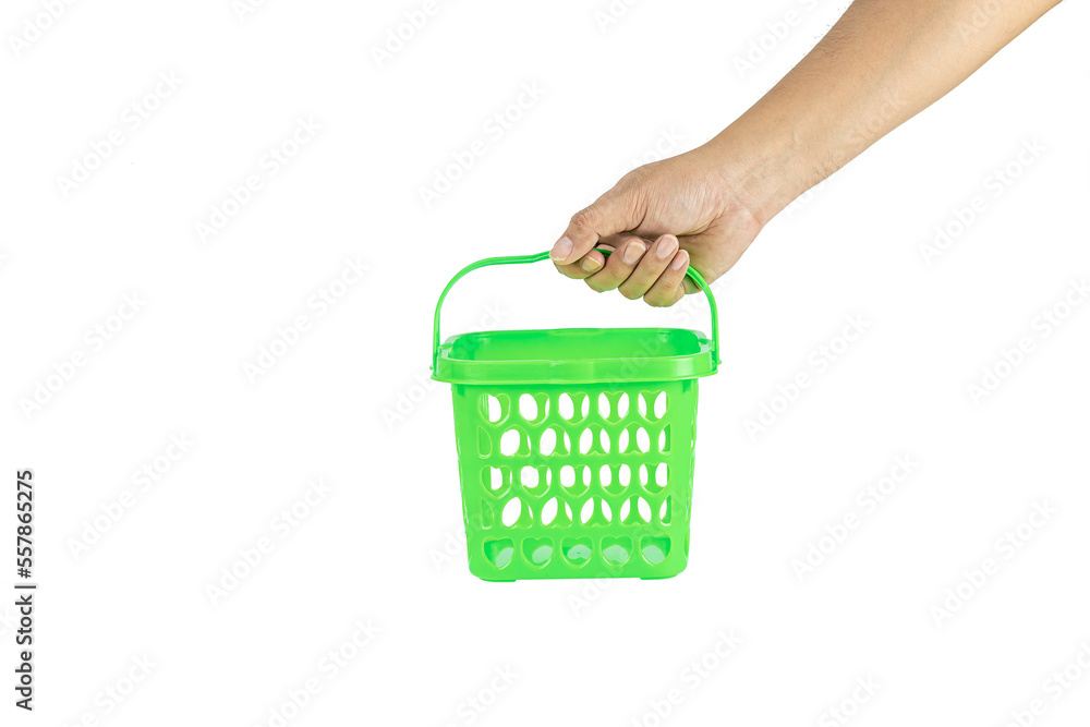 Fototapeta premium Hand holding green shopping basket isolated on white background with clipping path