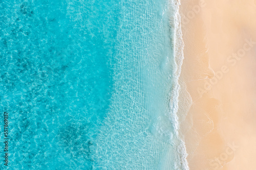 Summer seascape beautiful waves, blue sea water sunny day. Top drone view. Tranquil sea aerial amazing tropical nature Mediterranean. Beautiful bright sea waves splashing and beach sand sunset light