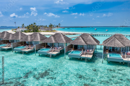 Tranquil aerial travel landscape, luxury tropical resort with pool villas. Beautiful island beach shore, lagoon bay. Amazing bird eyes view in Maldives, paradise coast. Exotic dream tourism relax sea