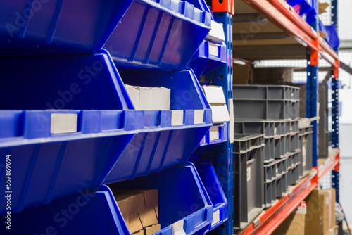 Storage bins and industrial storage racks in a warehouse shot with shallow focus