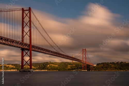 The "25 de Abril" suspension bridge (which translates to the "25th of April" Bridge) and the 'Cristo Rei' (which translates to "Christ the King") statue on the banks of the Tagus River in the capital