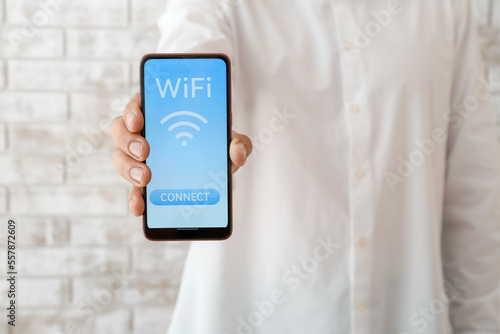 Man holding mobile phone wi...