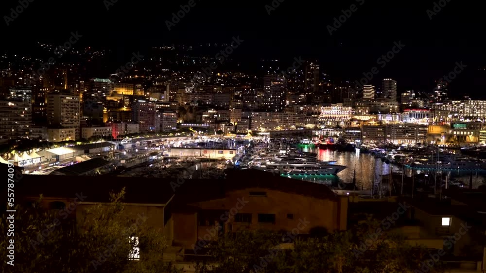 Monte Carlo View. Night view of Monaco. Monaco city and tiny state on the Mediterranean coast. Luxury resort in the south of France. Port with expensive yachts and ships in Monaco