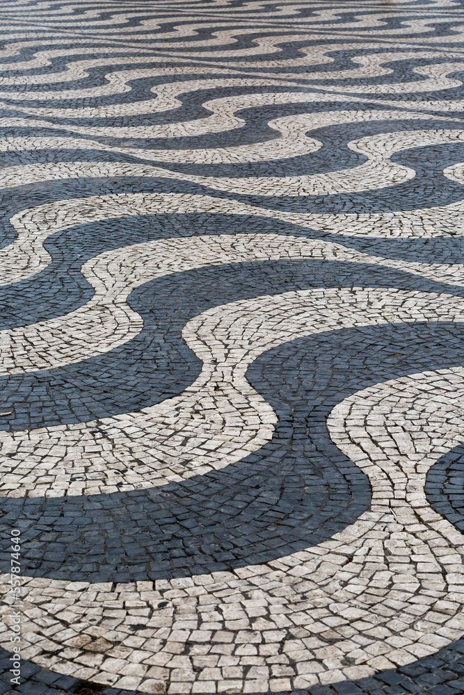 The traditional black and white paved tiles on the floors in many areas of Lisbon, Portugal The traditional black and white paved tiles on the floors in many areas of Lisbon, Portugal