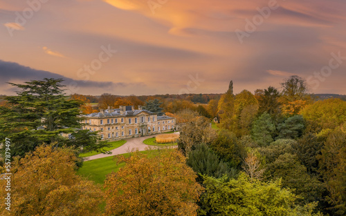 Bowcliffe Hall Yorkshire stately home, wedding venue and offices close to the A1, York, Leeds and Bramham Park. Drone photo showing the front of the main building and trees on an autumn day at sunset
