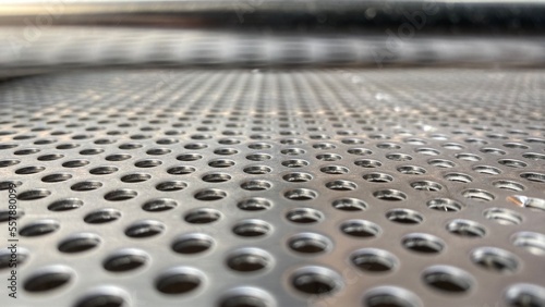 Metal checker plate abstract stainless steel round hole punch for background. 