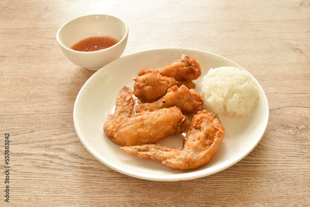 crispy fried chicken drumstick and wing dipping chili sauce eat with sticky rice on plate crispy fried chicken drumstick and wing dipping chili sauce eat with sticky rice on plate