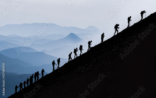 active and determined trekking of professional mountaineers to the summit and challenging sportive activities