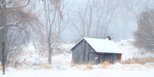Weathered and rusted wooden shack on a cold snowy day in autumn near Ottawa, Canada