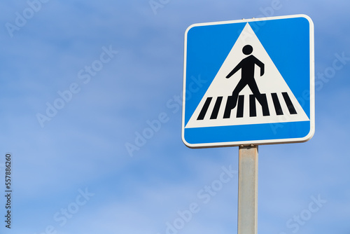 pedestrian crossing traffic sign over blue sky