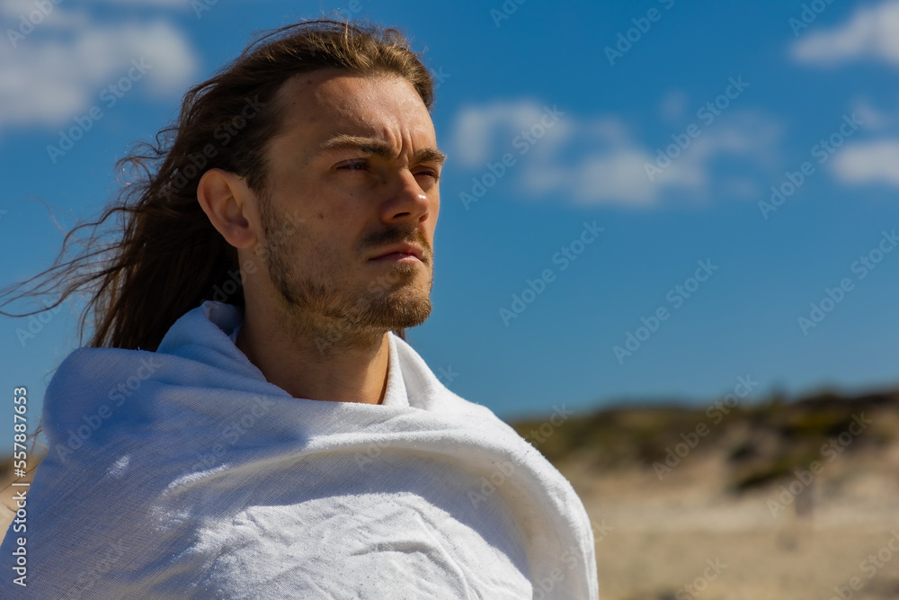 Portrait of a man who looks like Jesus Christ in desert