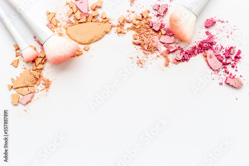 Nude colored makeup powder with brushes isolated on white background