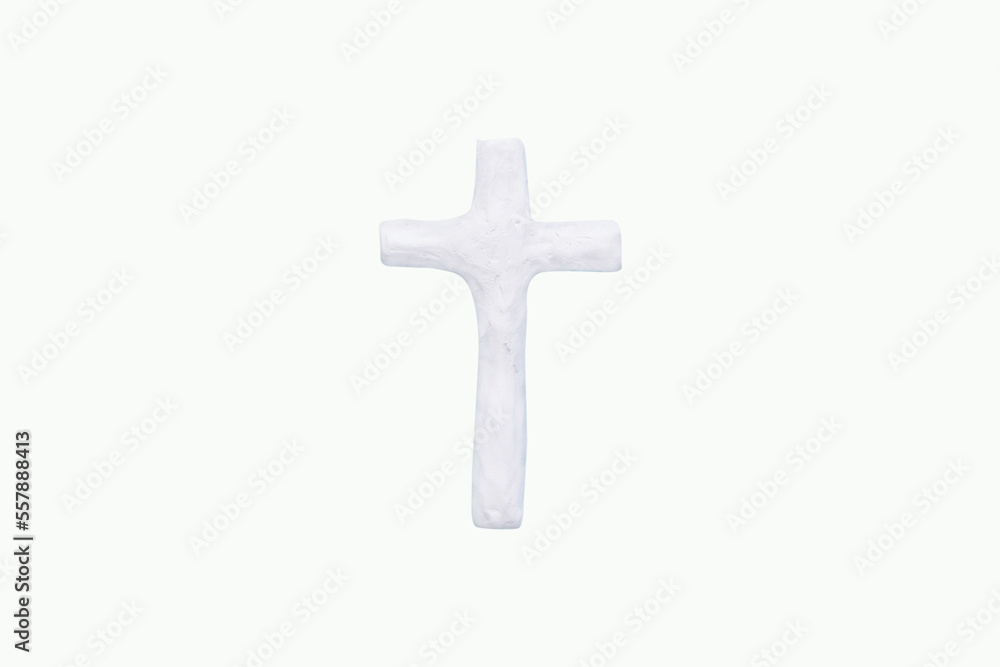 Plasticine cross on white background. Handmade clay plasticine. is a geometric sign. The cross is the oldest symbol used by humans. And used as a symbol of many religions including Christianity.