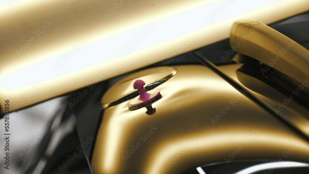 Close-up of the car body dent removal process. The car body has a golden shining color. . High quality 4k footage Close-up of the car body dent removal process. The car body has a golden shining color. . High quality 4k footage