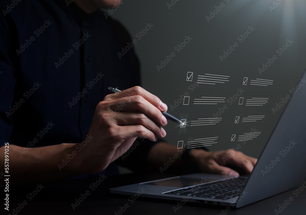 Businessman evaluating with checkboxes on online laptop computer. assessment survey online, choose correct answer in test, questions test, online exam, quiz knowledge, filling out an survey form. Businessman evaluating with checkboxes on online laptop computer. assessment survey online, choose correct answer in test, questions test, online exam, quiz knowledge, filling out an survey form.