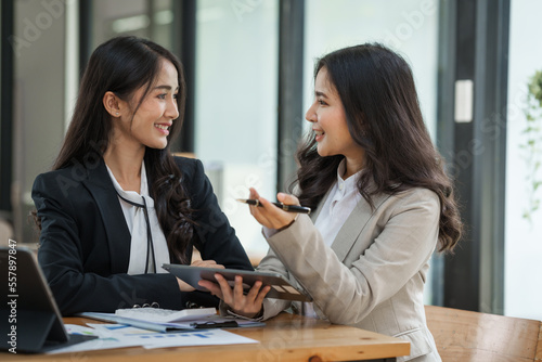 Asian company employees and colleagues work together in the office. by talking and giving advice to each other