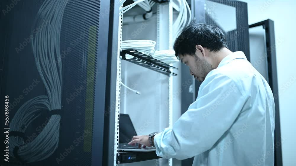 Computer engineer is setting up network in server room,Systems Maintenance Technician Computer engineer is setting up network in server room,Systems Maintenance Technician