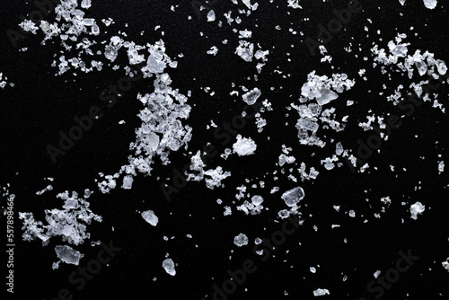 Transparent salt crystals on a black background.