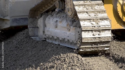 Bulldozer machine leveling construction site in close up view.