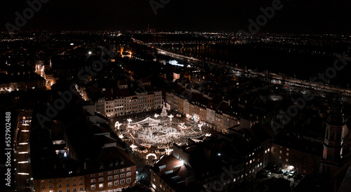 Aerial Christmas night of the Warsaw old town. Beautiful illuminated ice skating ring in the middle of the old town of Warsaw. © Aerial Film Studio