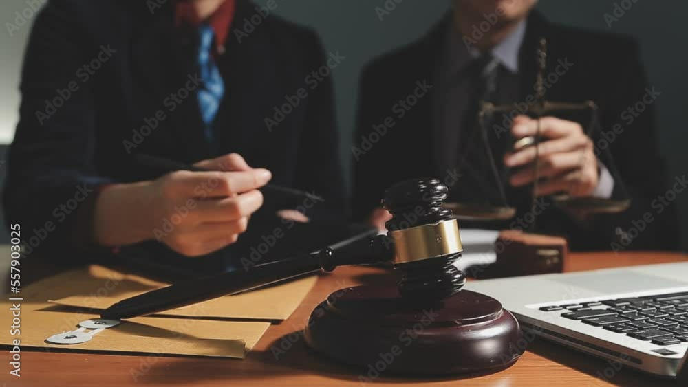 Business and lawyers discussing contract papers with brass scale on desk in office. Law, legal services, advice, justice and law concept picture with film grain effect Business and lawyers discussing contract papers with brass scale on desk in office. Law, legal services, advice, justice and law concept picture with film grain effect