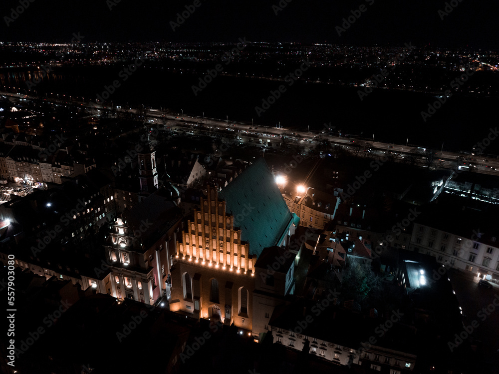 Aerial Christmas night of the Warsaw old town. Beautiful illuminated Christmas tree in the middle of the city.