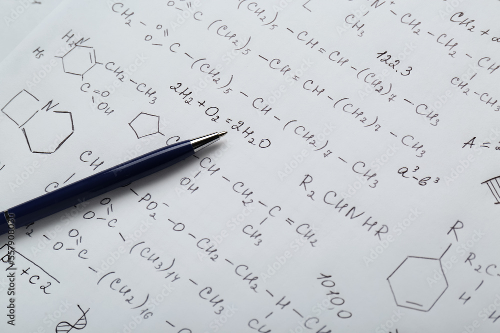 Sheet of paper with different chemical formulas and pen, closeup Sheet of paper with different chemical formulas and pen, closeup