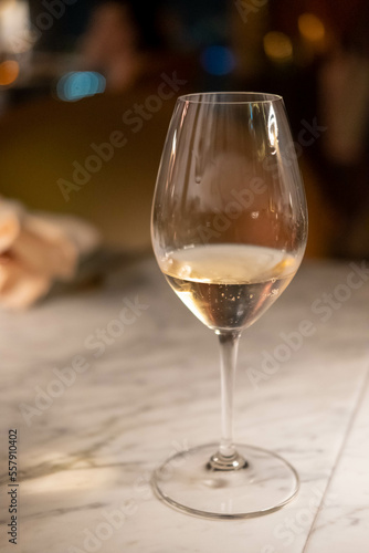 A glass of wine on the table, with blur background in the restaurant