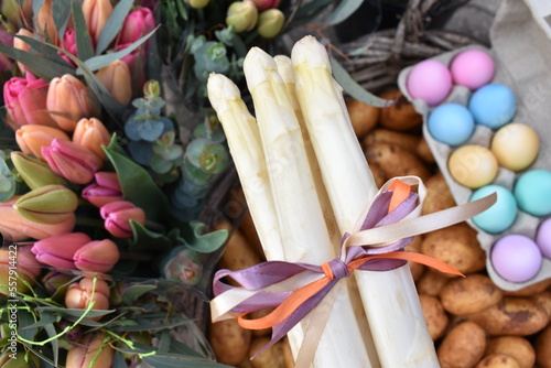 Photography White asparagus with bow, pastel eggs, fresh potatoes and tulips for easter